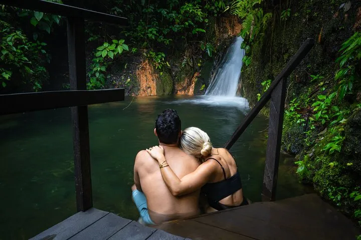 Mineral thermal pool surrounded by rainforest on a Sensoria hot springs and waterfall tour near Miravalles, Costa Rica