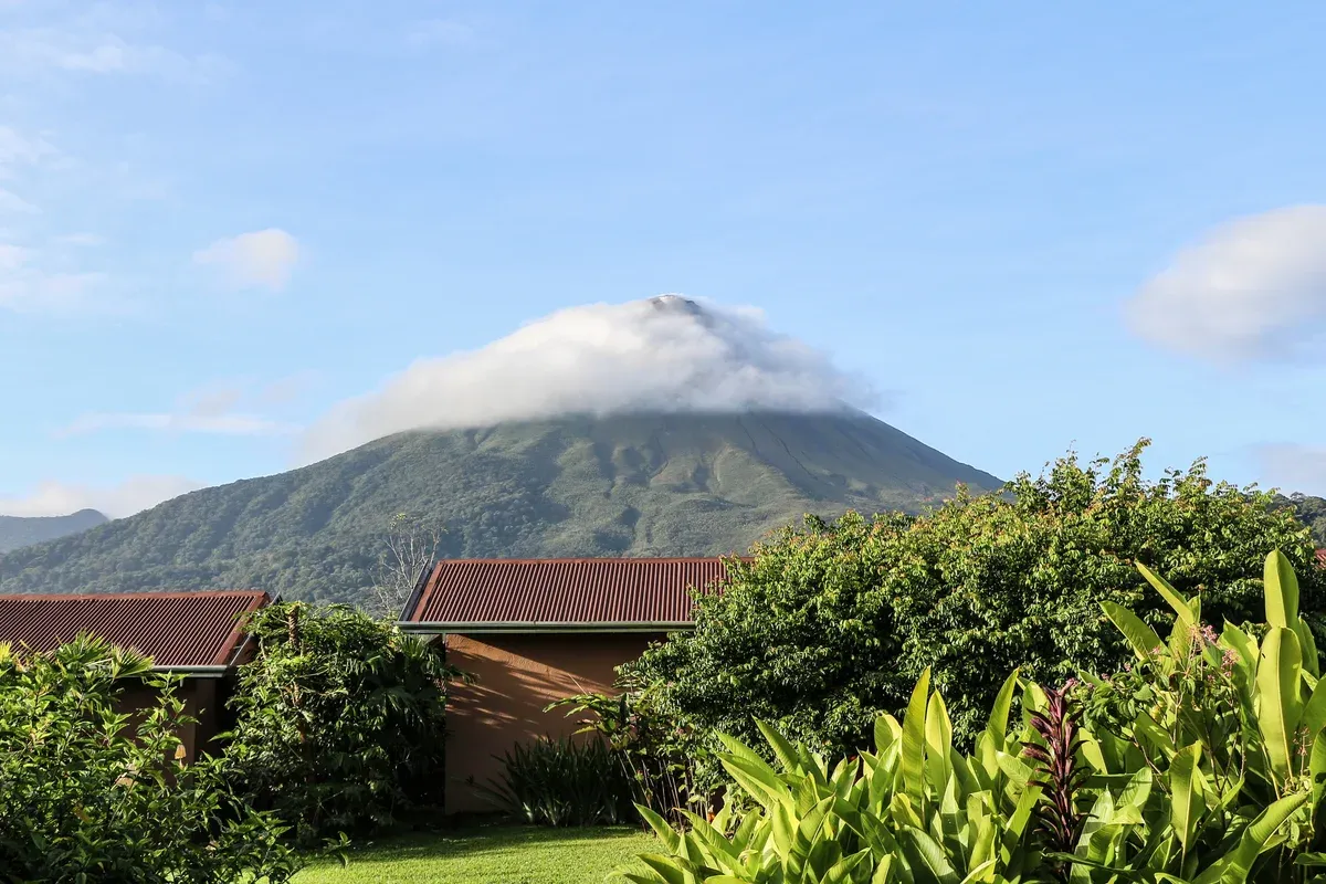 Arenal Volcano with a cloud on its summit above La Fortuna, the setting of Arenal Costa Rica hot springs tours