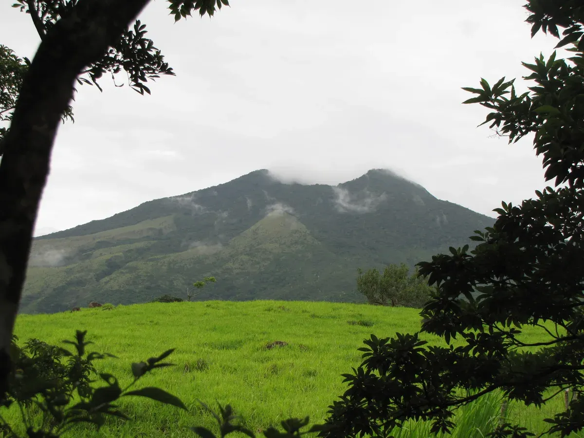 Miravalles Volcano above green pasture near Bagaces, the volcano behind Costa Rica hot springs tours in Guanacaste